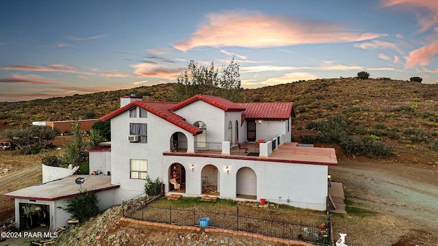 mediterranean / spanish home with a mountain view and a balcony