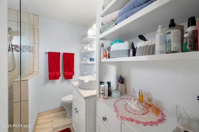 bathroom featuring tile patterned floors, vanity, and toilet