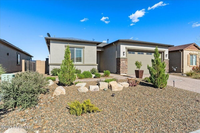 8935 N Tromontana Rd, Prescott Valley, AZ 86315 - prairie-style home featuring stucco siding, an attached garage, stone siding, fence, and driveway