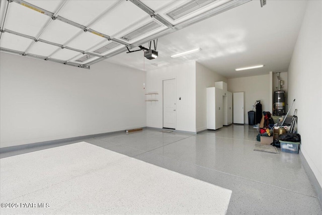 8935 N Tromontana Rd, Prescott Valley, AZ 86315 - garage with a garage door opener, water heater, and baseboards