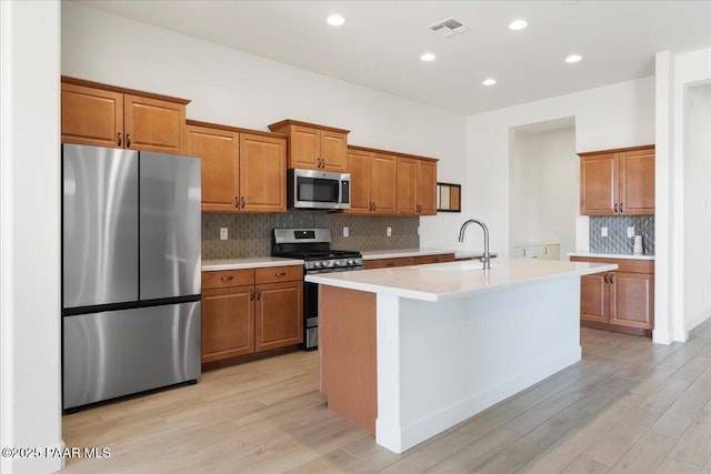 8935 N Tromontana Rd, Prescott Valley, AZ 86315 - kitchen with stainless steel appliances, a sink, brown cabinets, and recessed lighting
