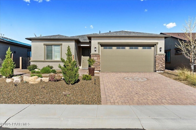 8935 N Tromontana Rd, Prescott Valley, AZ 86315 - prairie-style home featuring stucco siding, stone siding, decorative driveway, and a garage