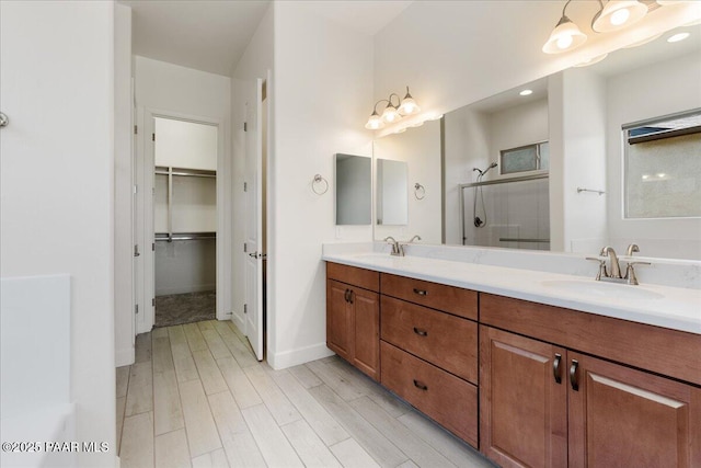 8935 N Tromontana Rd, Prescott Valley, AZ 86315 - full bathroom with a shower stall, wood finished floors, a spacious closet, double vanity, and baseboards