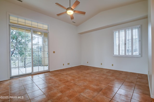 spare room featuring a wealth of natural light, lofted ceiling, ceiling fan, and light tile patterned floors