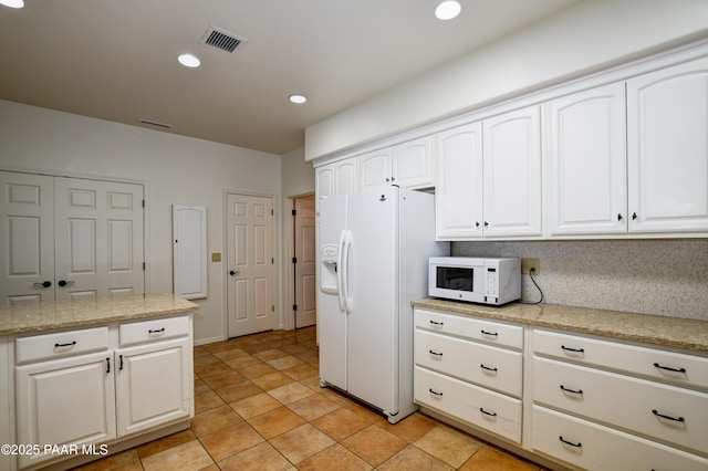 kitchen with recessed lighting, visible vents, white appliances, and white cabinetry