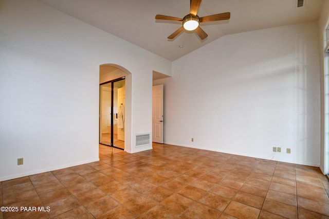 unfurnished room featuring visible vents, baseboards, arched walkways, lofted ceiling, and ceiling fan