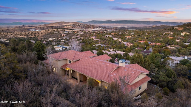 aerial view at dusk featuring a mountain view