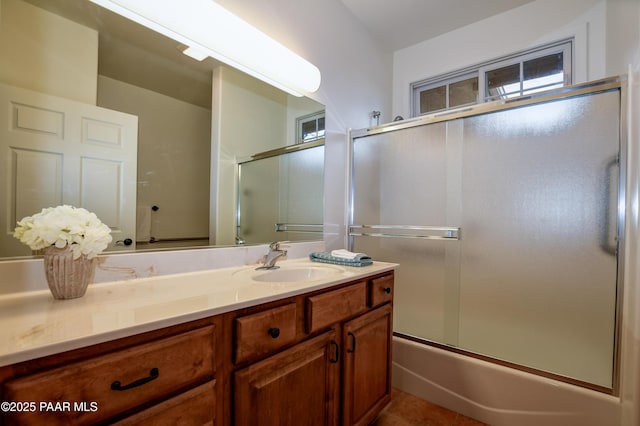 bathroom featuring vanity and enclosed tub / shower combo