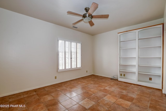 unfurnished room featuring visible vents, baseboards, and a ceiling fan