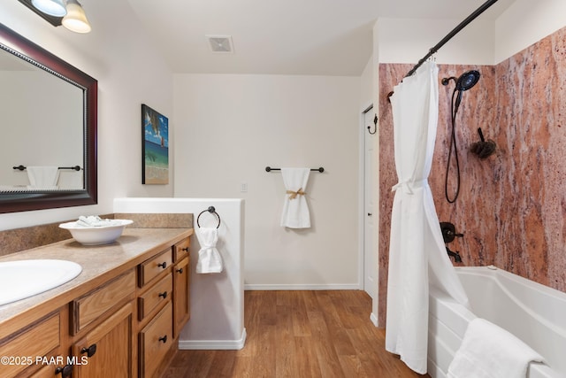 bathroom with vanity, hardwood / wood-style floors, and shower / bath combo with shower curtain