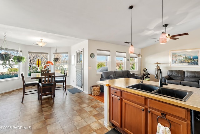 kitchen with black dishwasher, sink, and hanging light fixtures
