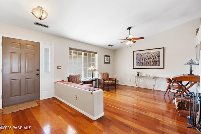 foyer entrance with wood-type flooring and ceiling fan