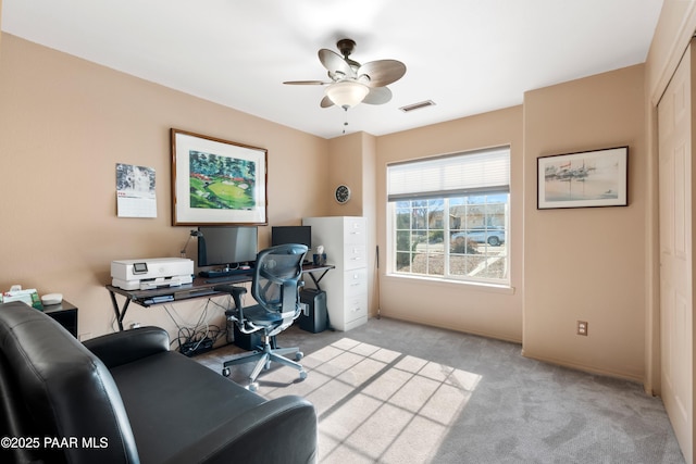 carpeted office with ceiling fan