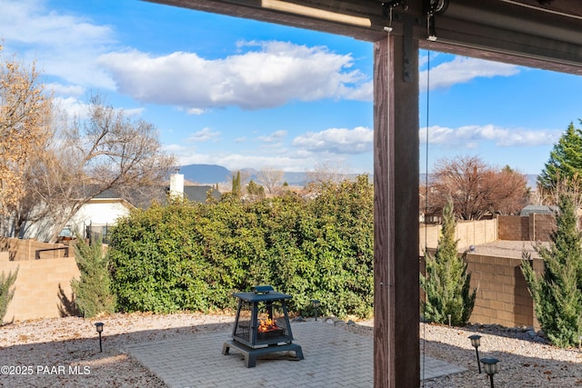 exterior space with a mountain view, a patio area, and an outdoor fire pit