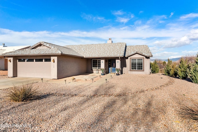 ranch-style house featuring a garage
