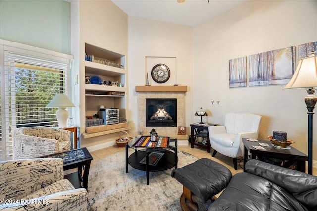 living room featuring a fireplace, built in shelves, and light tile patterned flooring