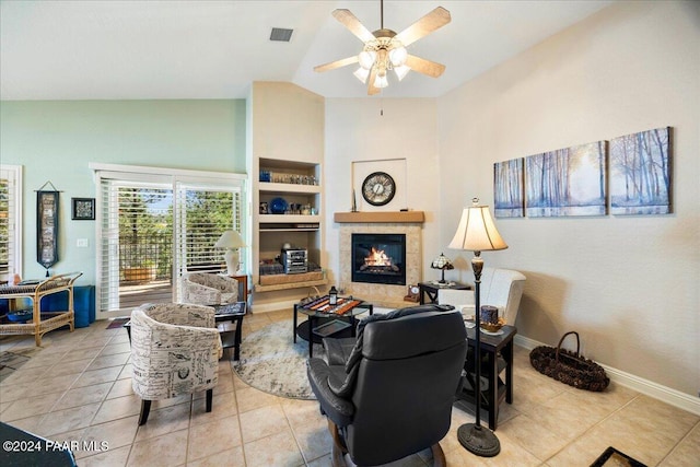 tiled living room featuring ceiling fan, a fireplace, and high vaulted ceiling