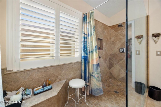 bathroom featuring tile patterned floors, tile walls, and a shower with shower curtain