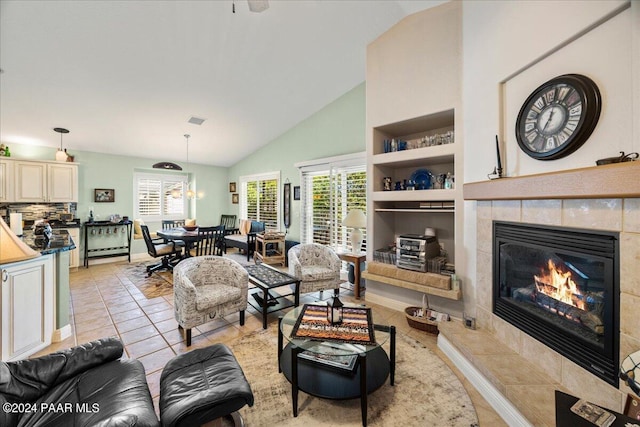 tiled living room featuring a notable chandelier, built in shelves, a fireplace, and high vaulted ceiling