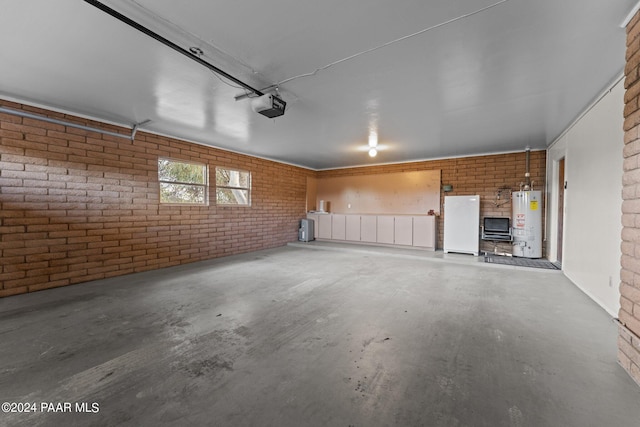 garage featuring water heater, a garage door opener, and white refrigerator