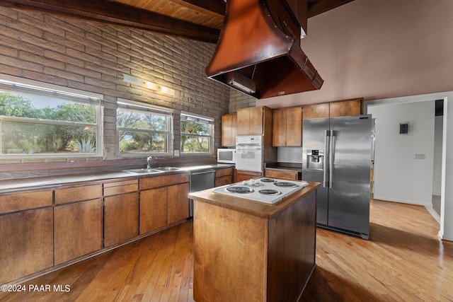 kitchen with sink, light hardwood / wood-style flooring, extractor fan, and appliances with stainless steel finishes