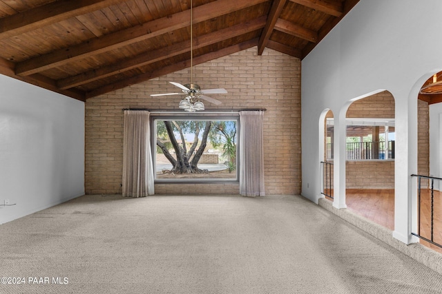 unfurnished living room featuring wood ceiling, brick wall, ceiling fan, beamed ceiling, and hardwood / wood-style floors