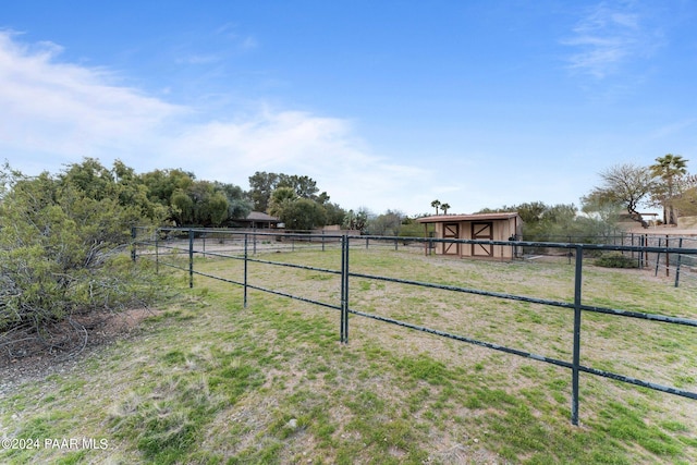 view of yard featuring an outbuilding and a rural view