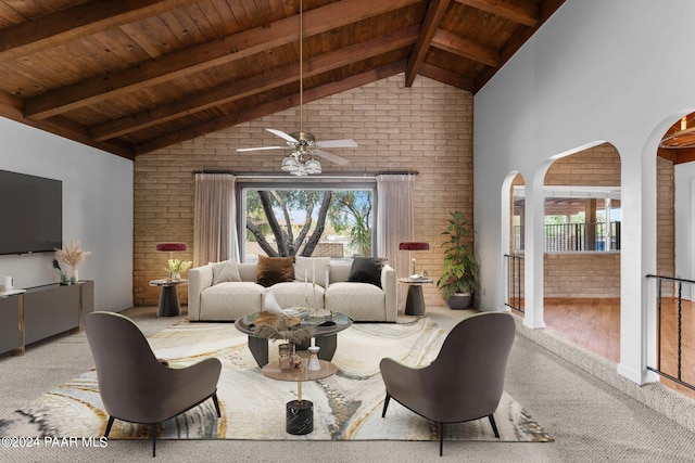 living room featuring ceiling fan, light wood-type flooring, beamed ceiling, wood ceiling, and brick wall