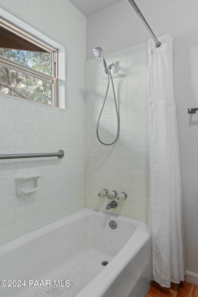 bathroom featuring shower / bathtub combination with curtain