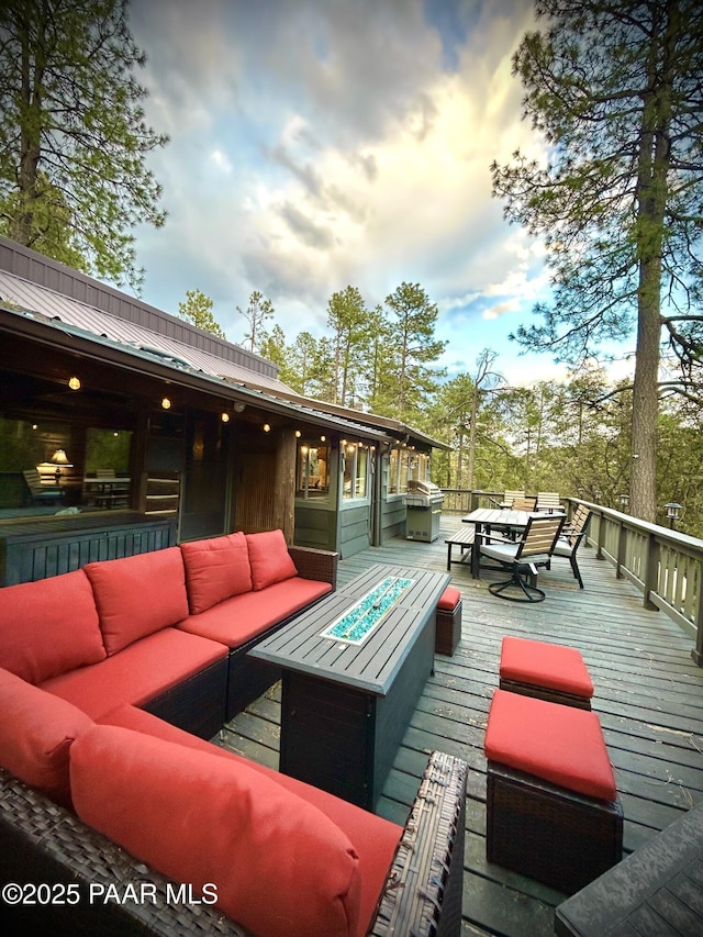 3702 E Pine Mountain Rd, Prescott, AZ 86303 - wooden terrace featuring a grill, outdoor dining area, and an outdoor living space with a fire pit