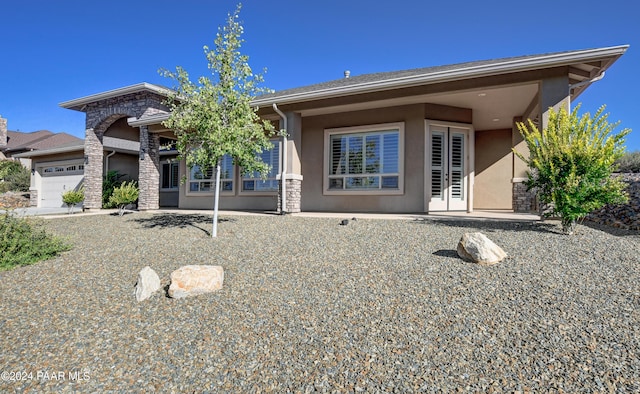 back of house featuring a garage