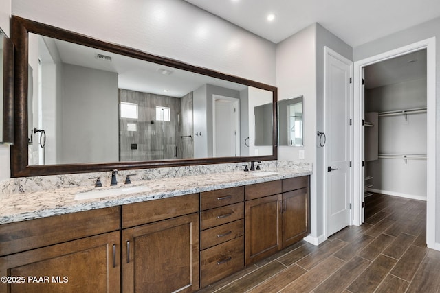 5357 Crescent Edge Dr, Prescott, AZ 86301 - bathroom with a shower stall, double vanity, wood finished floors, baseboards, and recessed lighting