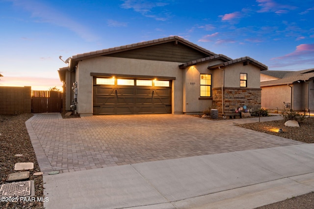 5357 Crescent Edge Dr, Prescott, AZ 86301 - ranch-style home featuring decorative driveway, an attached garage, stucco siding, and a tiled roof