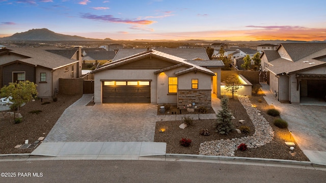 5357 Crescent Edge Dr, Prescott, AZ 86301 - view of front of home featuring decorative driveway, a tiled roof, stucco siding, an attached garage, and fence