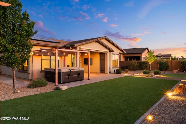 5357 Crescent Edge Dr, Prescott, AZ 86301 - rear view of house with a hot tub, a patio, roof mounted solar panels, and stucco siding