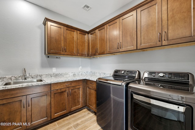 5357 Crescent Edge Dr, Prescott, AZ 86301 - washroom featuring light wood-style flooring, washer and dryer, and cabinet space