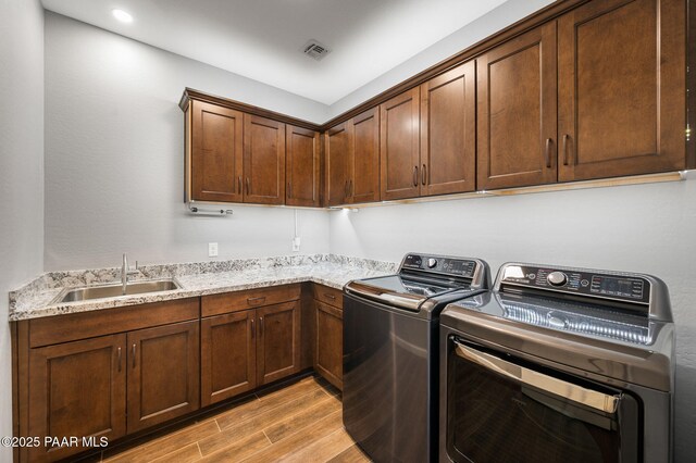 5357 Crescent Edge Dr, Prescott, AZ 86301 - laundry room with light wood-type flooring, independent washer and dryer, and cabinet space