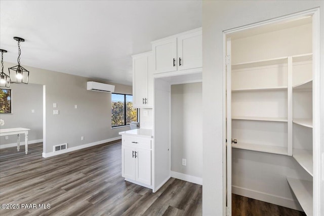 1287 N Lois Dr, Prescott, AZ 86301 - kitchen featuring an AC wall unit, white cabinetry, dark wood finished floors, and light countertops
