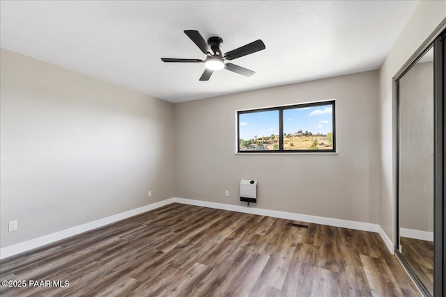 1287 N Lois Dr, Prescott, AZ 86301 - unfurnished bedroom featuring a closet, wood finished floors, ceiling fan, and heating unit