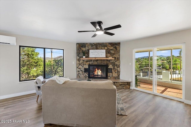 1287 N Lois Dr, Prescott, AZ 86301 - living room featuring a wall mounted air conditioner, wood finished floors, ceiling fan, and a fireplace