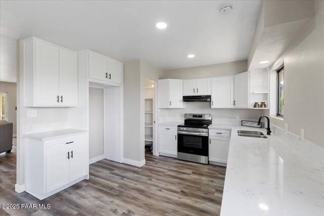 1287 N Lois Dr, Prescott, AZ 86301 - kitchen with stainless steel range with electric stovetop, open shelves, under cabinet range hood, light stone counters, and wood finished floors
