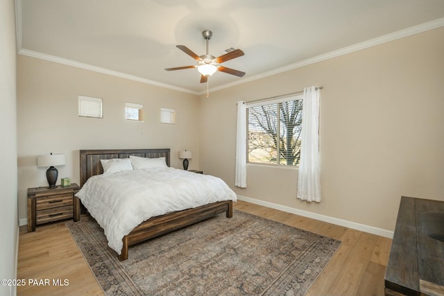 bedroom featuring ceiling fan, light hardwood / wood-style floors, and ornamental molding