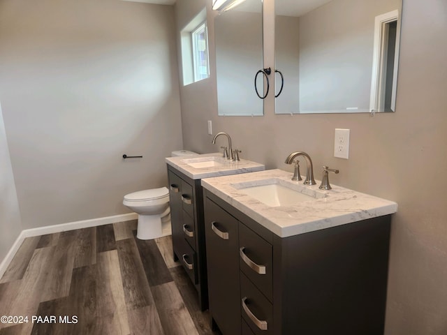 bathroom with vanity, hardwood / wood-style floors, and toilet