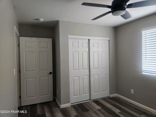 unfurnished bedroom with dark hardwood / wood-style floors, ceiling fan, and a closet