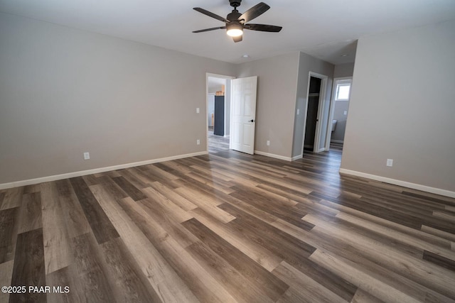 unfurnished room featuring dark wood-type flooring and ceiling fan