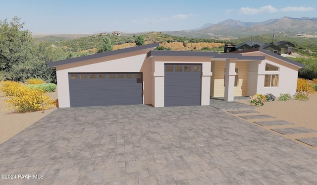 view of front of home featuring a mountain view and a garage