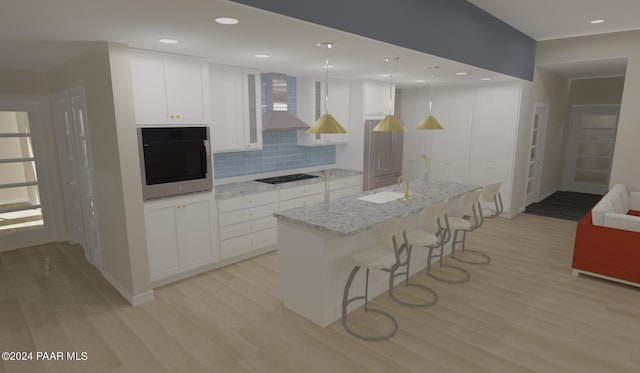 kitchen featuring wall oven, wall chimney exhaust hood, a center island with sink, white cabinets, and light hardwood / wood-style floors