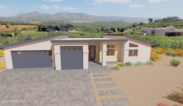 view of front of home featuring a mountain view and a garage