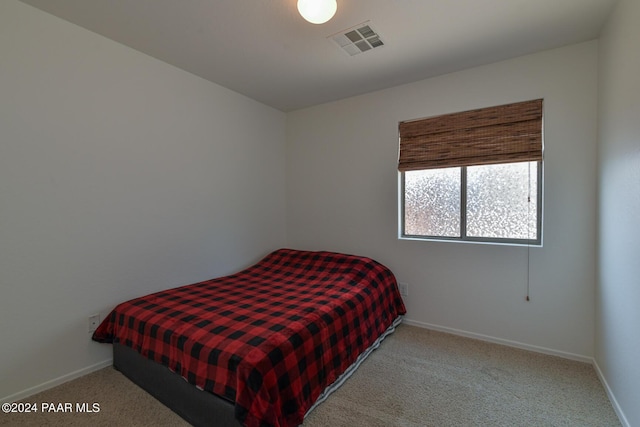 bedroom with light colored carpet