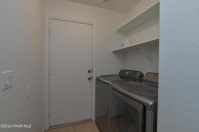 laundry room featuring independent washer and dryer and light tile patterned floors